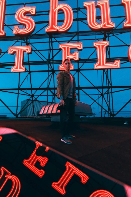 man sitting on a skateboard near neon signs