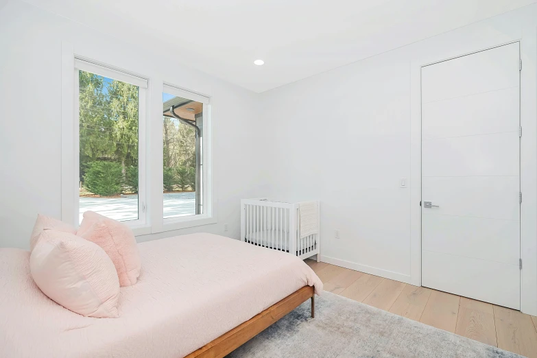 a large bedroom with a window and white walls