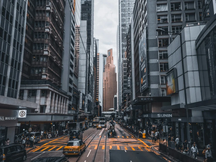 city buildings with yellow street markers and cars on the streets