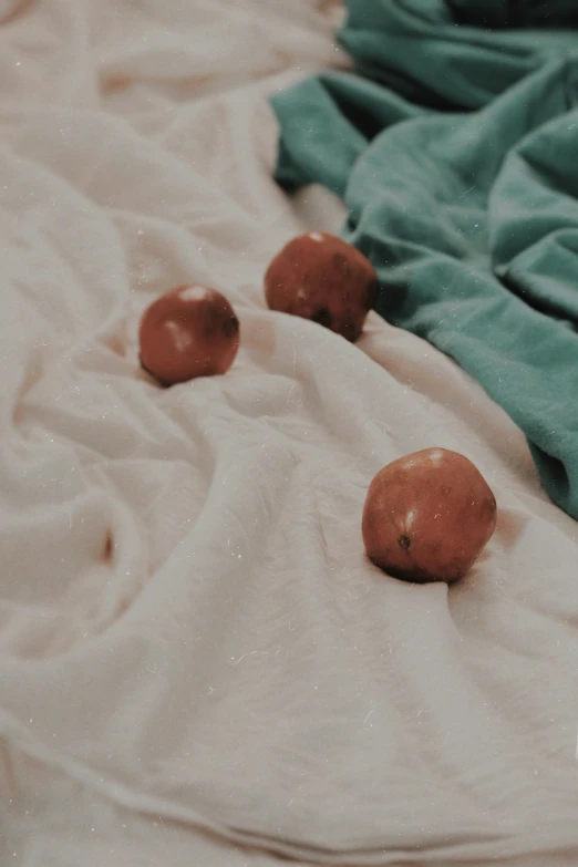 a group of balls are laying down on a sheet