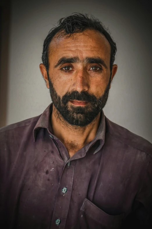 a man with a beard poses for the camera