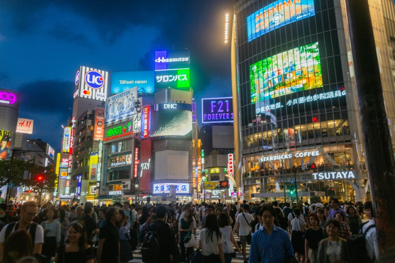 many people crossing the street on a busy city street