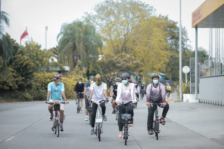 people in costume on bikes ride down the street