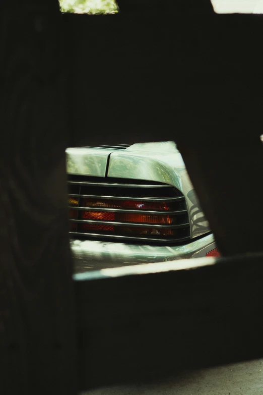 a car parked in a parking lot next to another vehicle