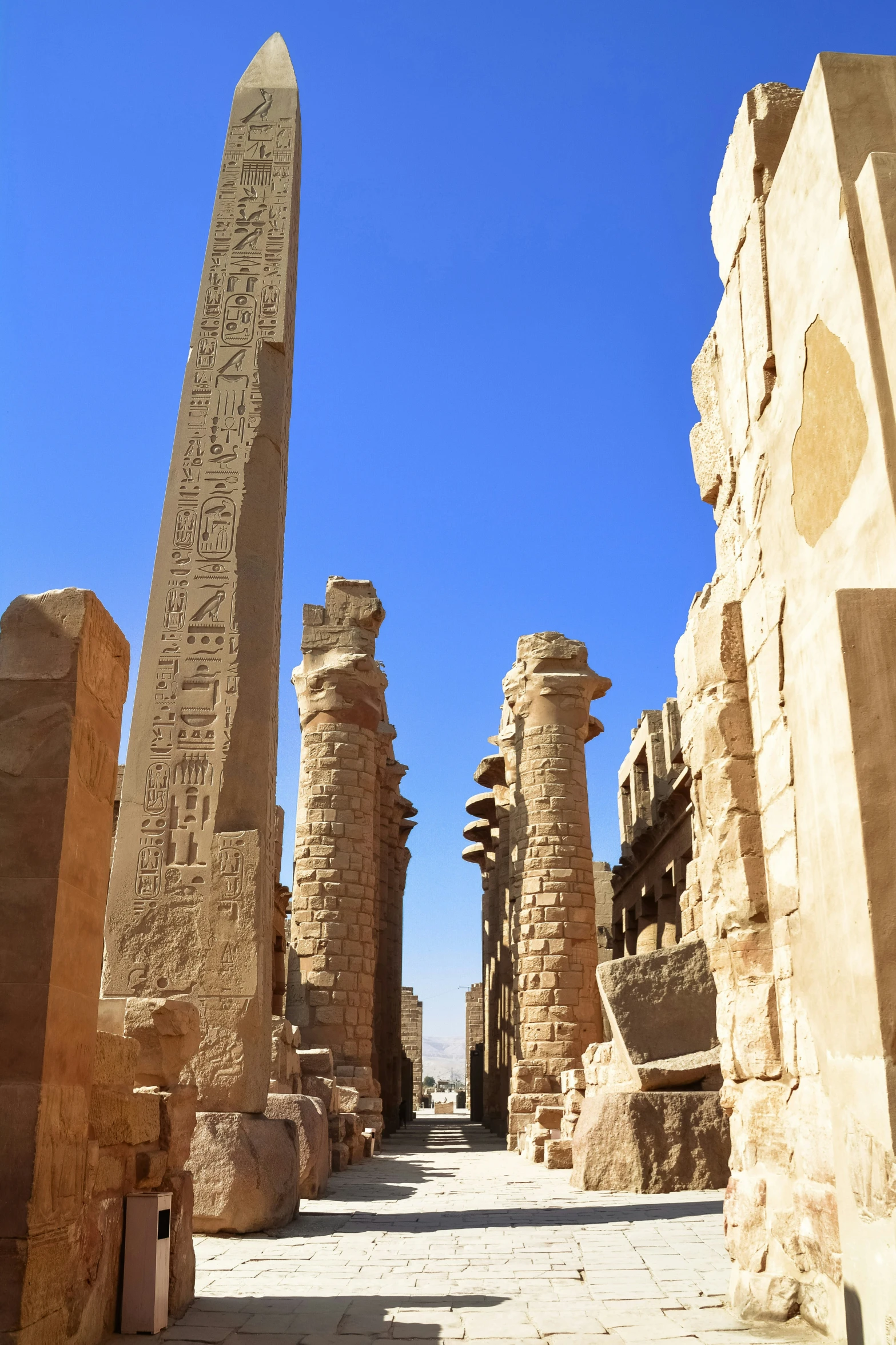 an old city street between two huge stone structures