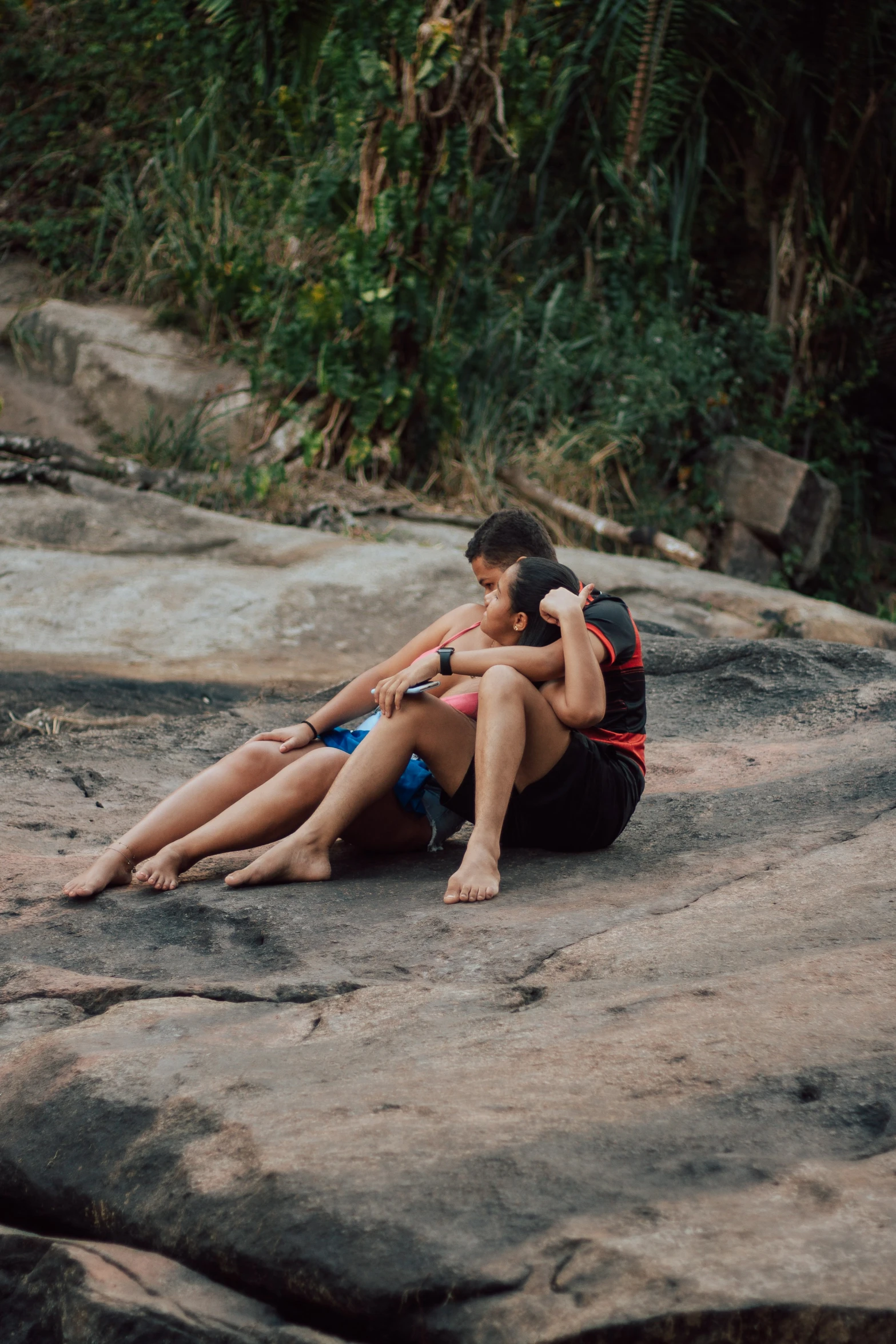 a couple is kissing on a rock