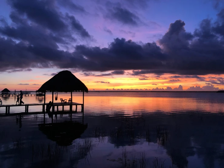 some boats are in the water at sunset