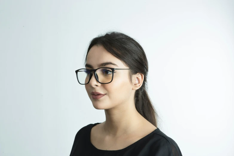 a girl with glasses posing for the camera