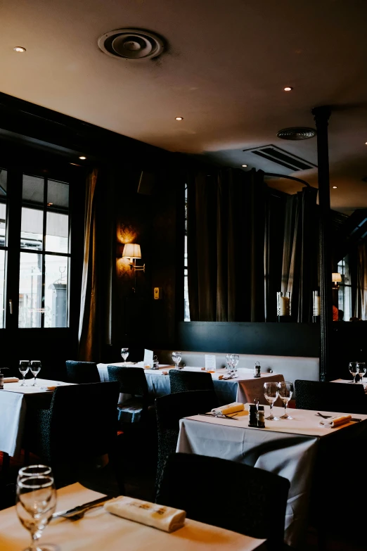 the dining area of a restaurant with table cloths