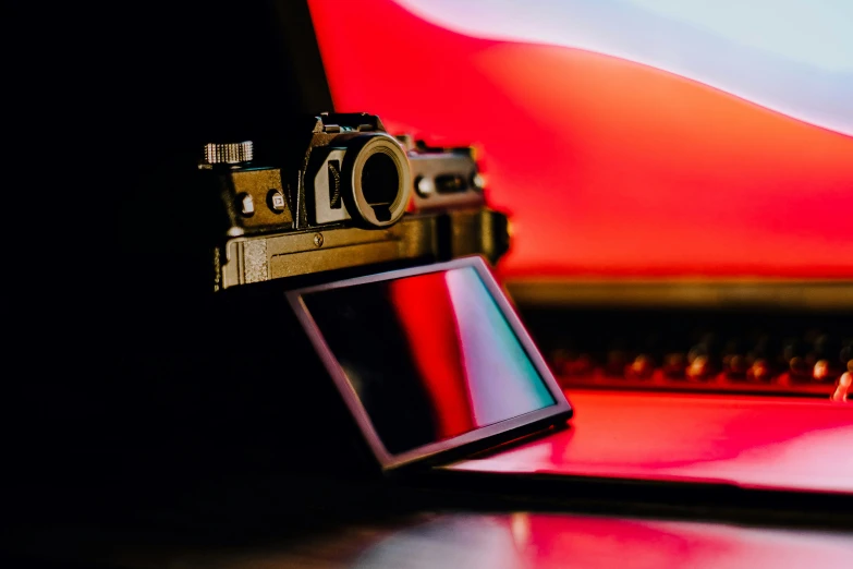 a flash camera sitting next to a laptop computer