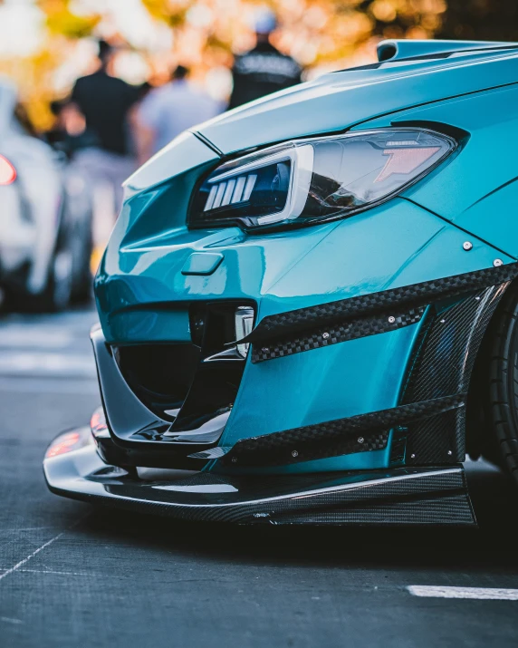 the rear of a blue car parked on a street