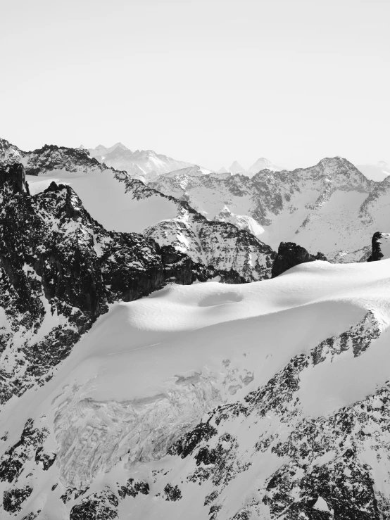 a snowboarder is standing on a snowy mountain side