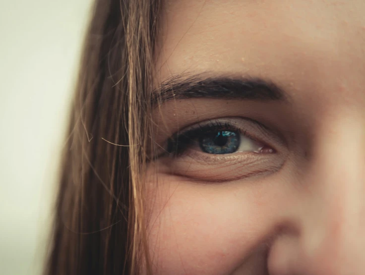 a close up of a womans blue eyes