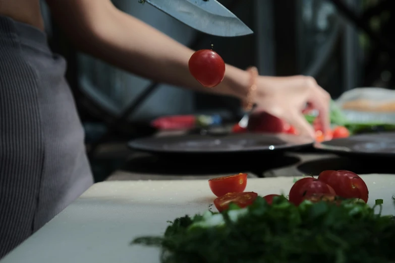 a person chops tomatoes on a  board