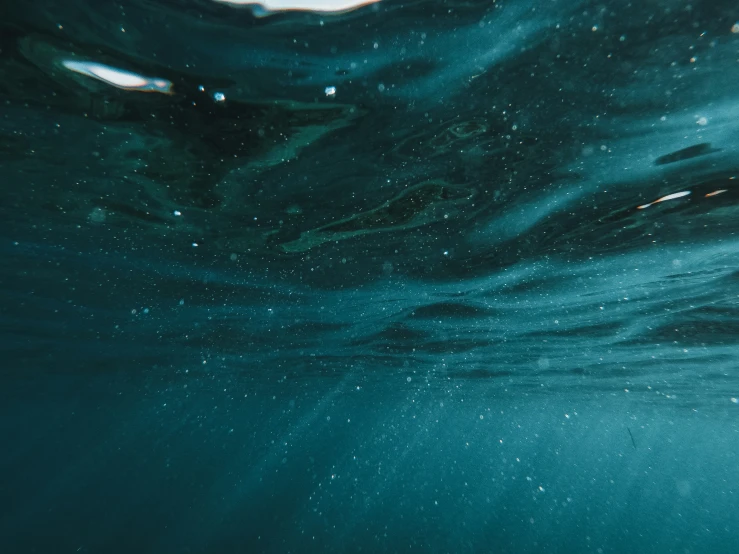 a man with a surfboard under some water