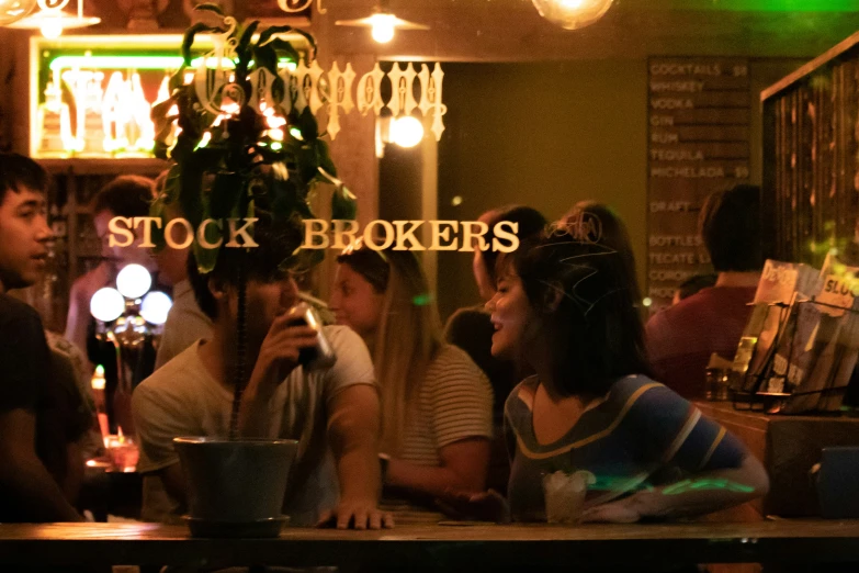 a group of people sitting in front of a green light