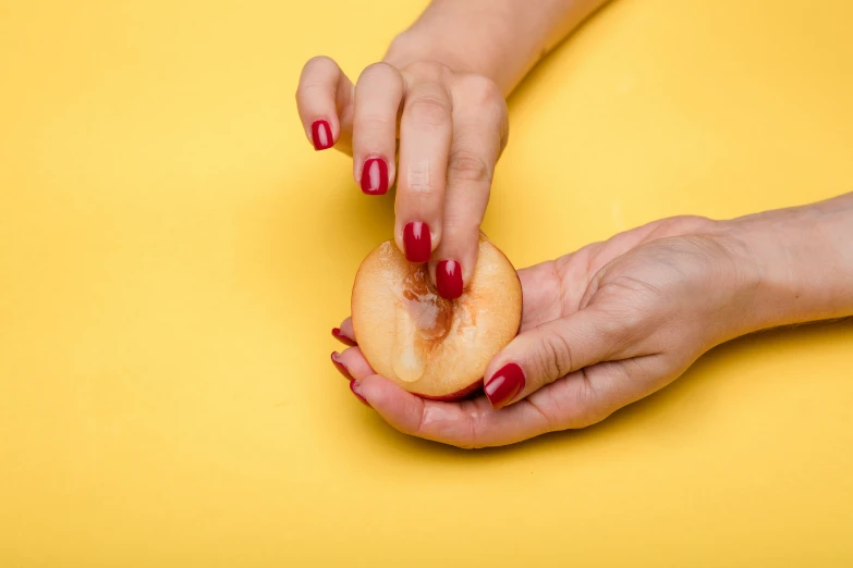 two hands are holding soing yellow on the yellow surface