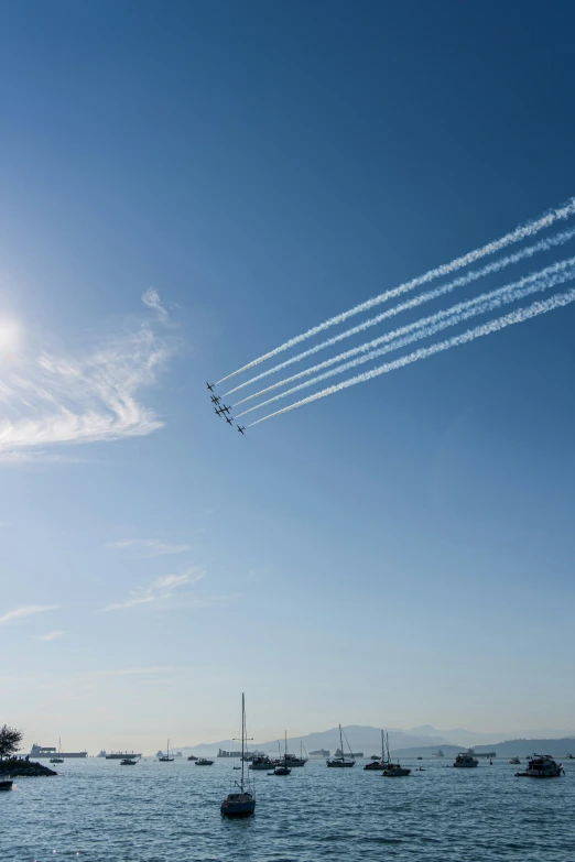 four jet planes fly across the clear blue sky