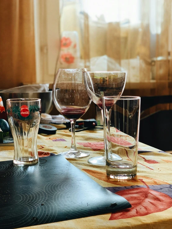 a table has glasses on it with dishes nearby