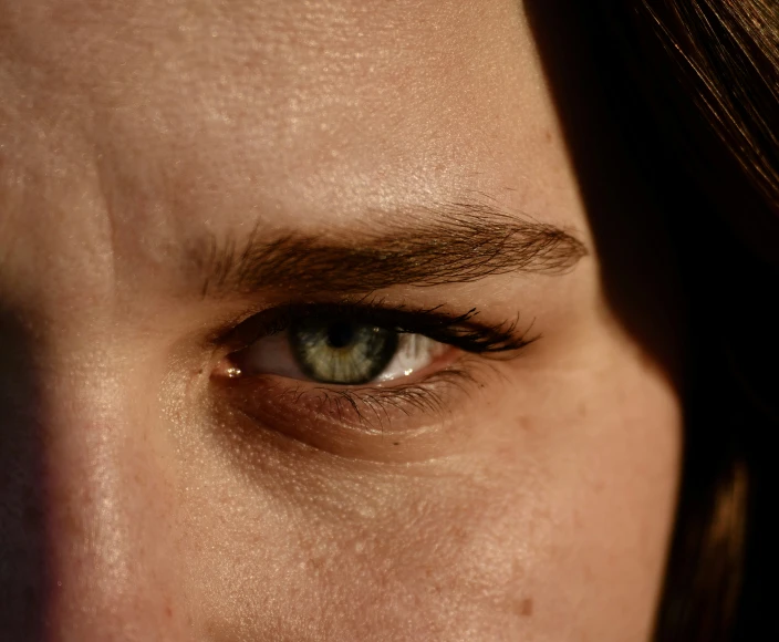 an eye showing the shadow of the person's hair