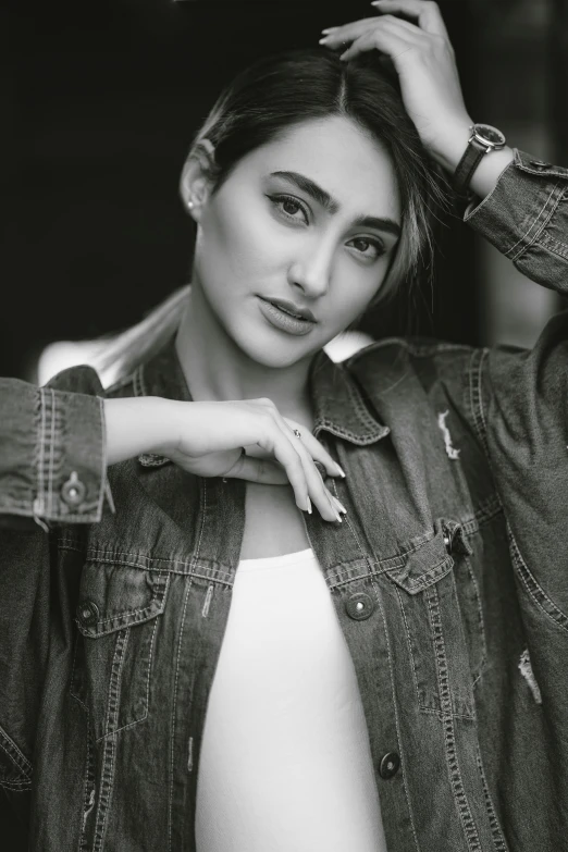 a woman with a denim jacket and ring celet