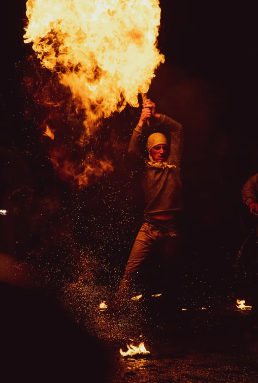 a man in a white baseball cap throwing fire