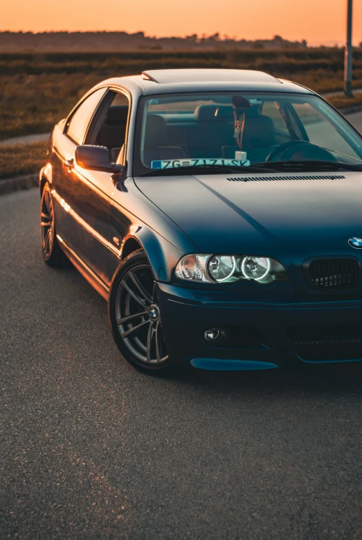 an image of a bmw on a road at dusk