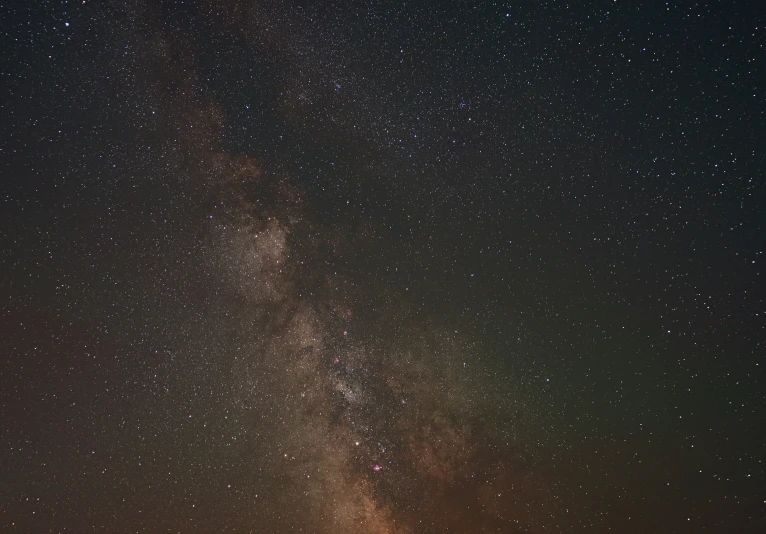 milky over the clouds in the night sky