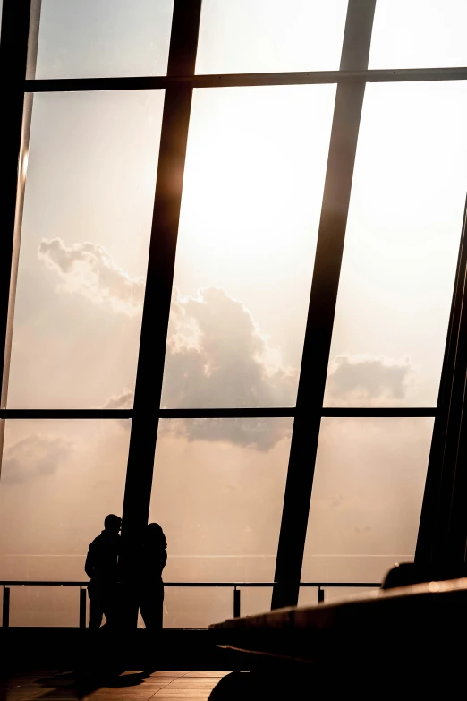 two people standing next to each other in an airport