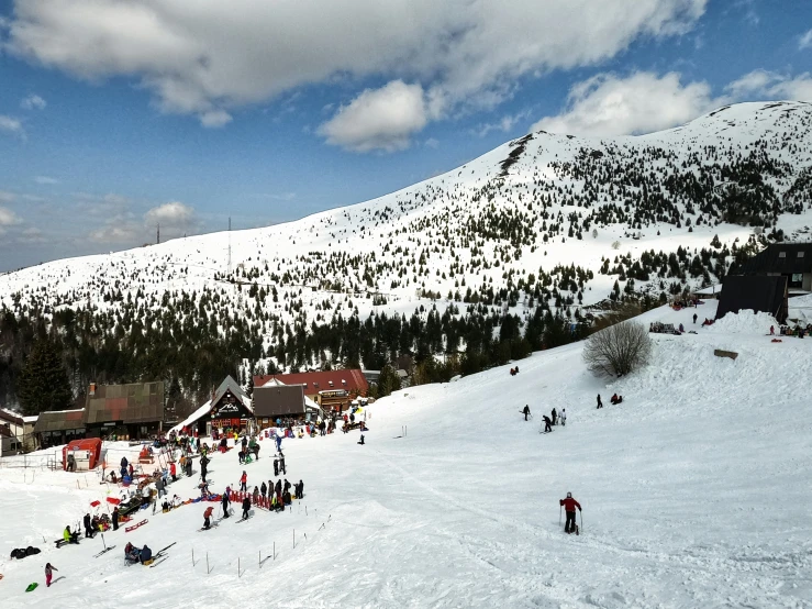 a group of people on skis near the slopes of a mountain