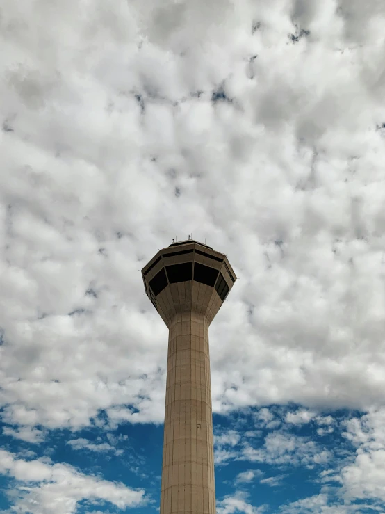 a tall tower sitting under a cloudy blue sky