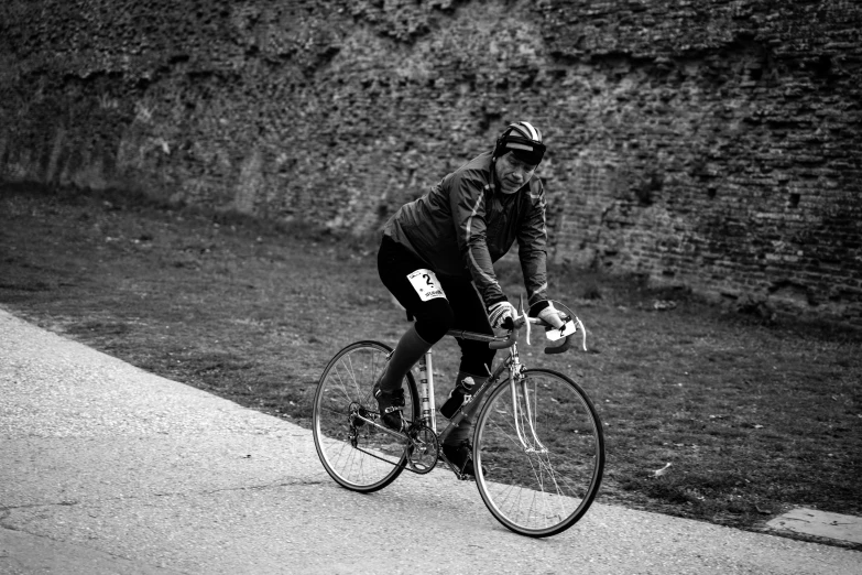 a black and white po of a man riding a bike