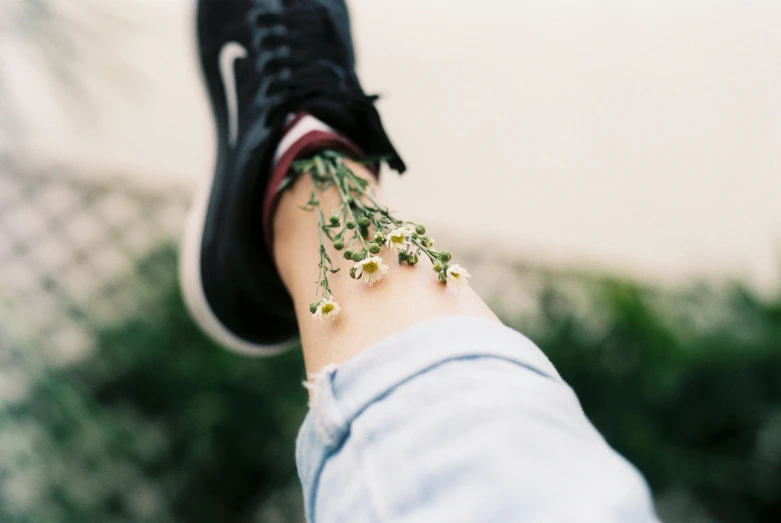 a person's foot with tiny plants growing from the inside of it