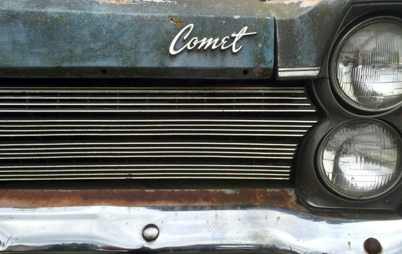 a rusted car with the words comet written on it