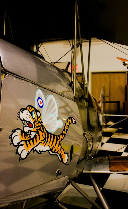 close up of a metal airplane with a tiger on the nose