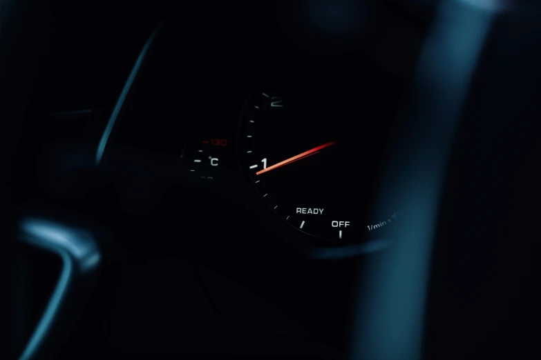 an interior of a car at night with meter lights on