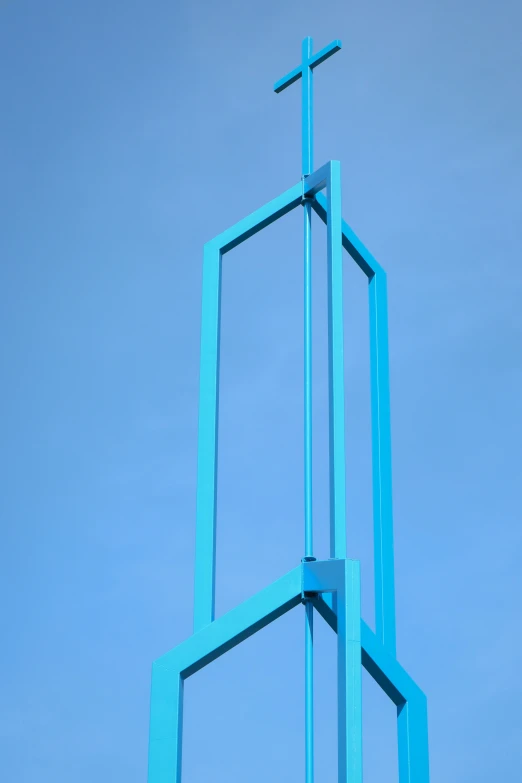 a cross on the top of a building with blue sky