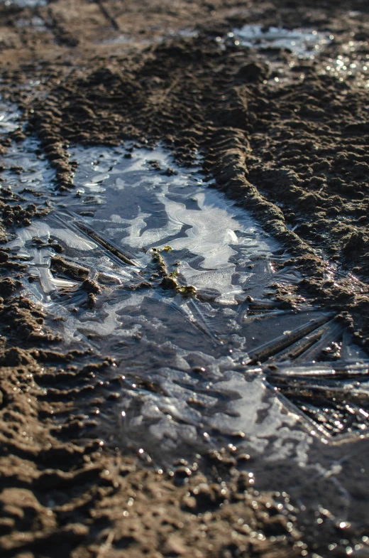 wet sand with a hole and water with small drops