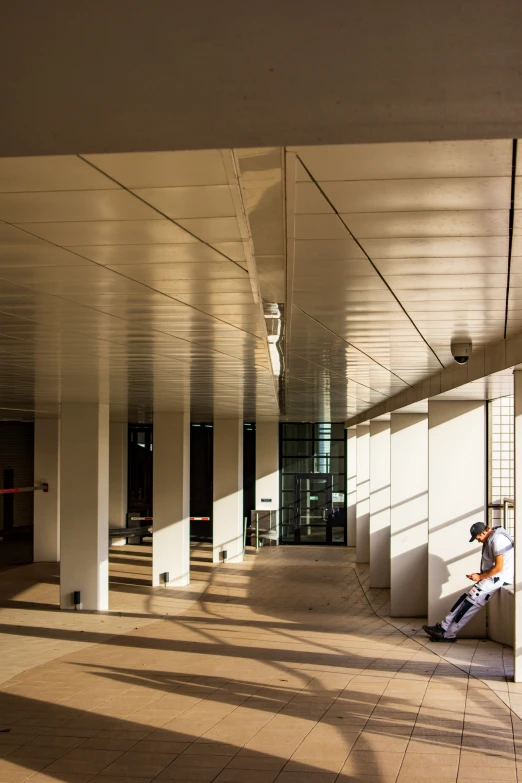 a man standing in a hallway next to an open window