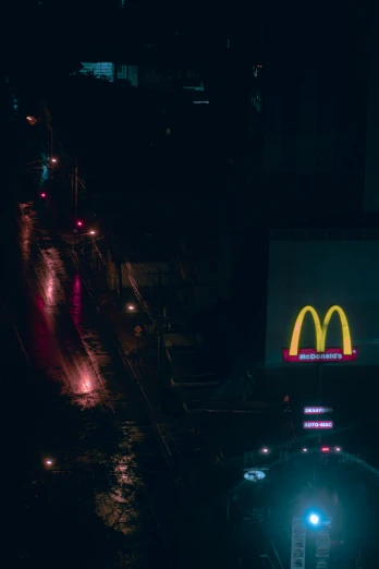 an illuminated neon sign and a dark city street