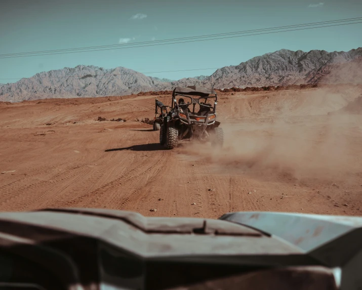 a man driving a vehicle in the desert