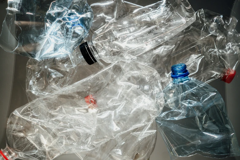 many bottles, glass containers, and red straw are scattered on the surface