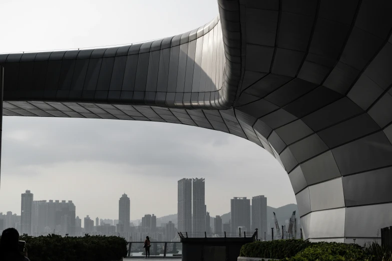 a person walking down the walkway of an artistic building