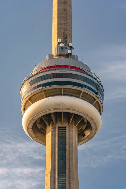 the tall tower has a statue on top of it