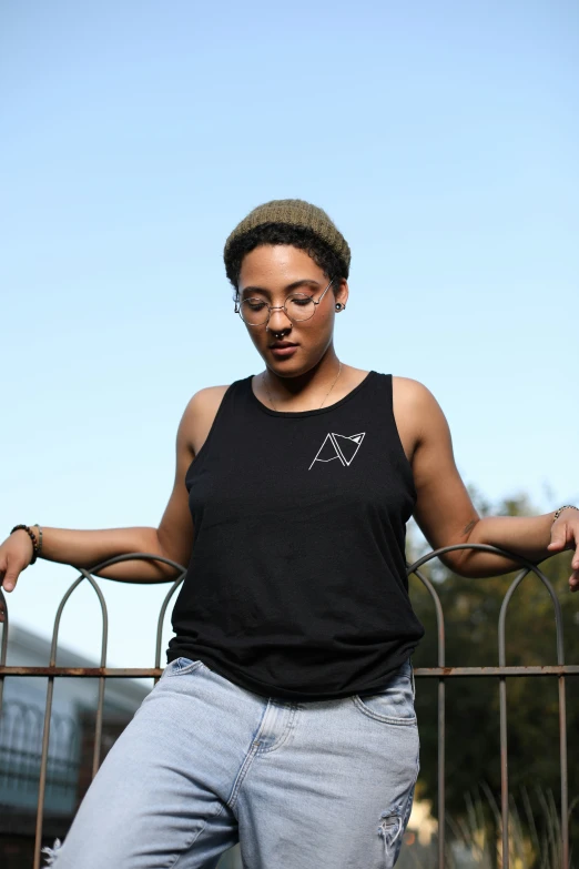 a person leaning over a fence with their hand on the rail