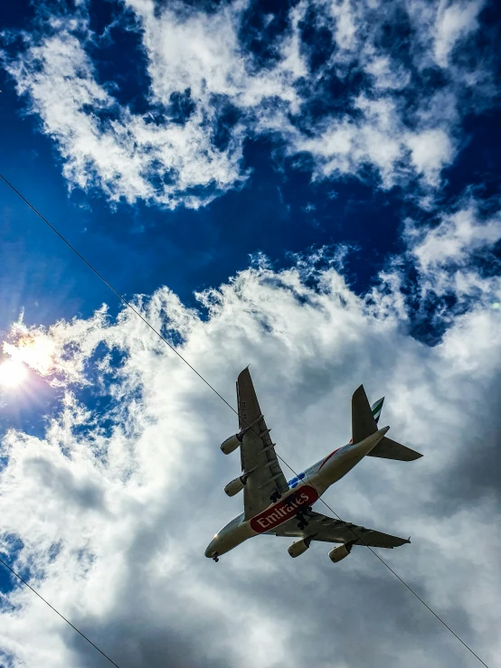 a large passenger jet flying through a cloudy blue sky