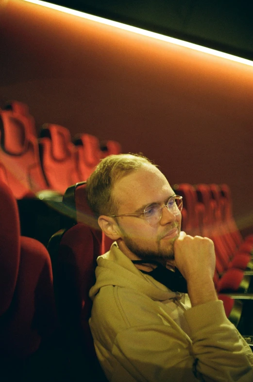 a man is smiling while sitting on a bench