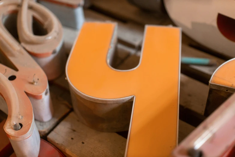 the letter u is shaped up with a pair of pliers