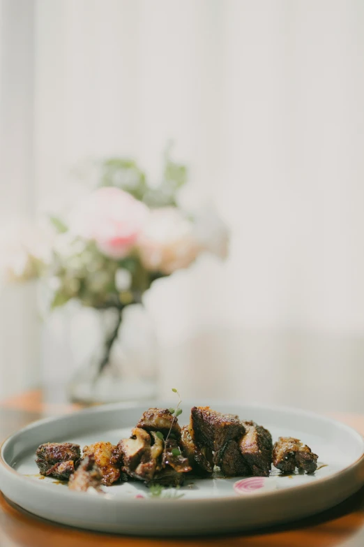 a white plate with some food on a wooden table