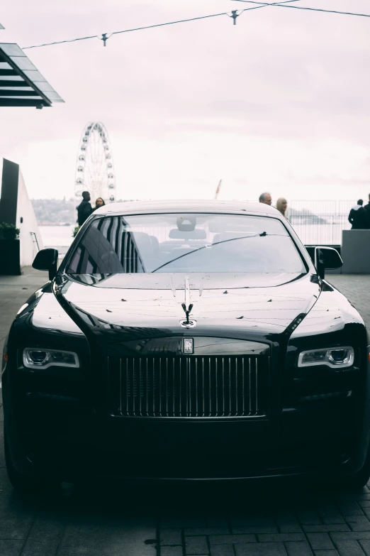 a black rolls royce in front of an observation deck